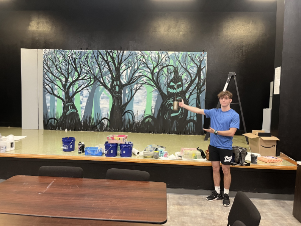 An Iowa Park Texas student points to his artwork for the upcoming Wizard of Oz at Iowa Park High School. If you're in the Wichita Falls or Iowa Park area, come grab some tickets and join us for a show!